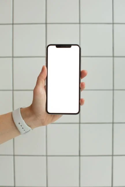 A polished smartphone showcasing artwork in a pared-back setting, ideal for technology and design-focused themes.